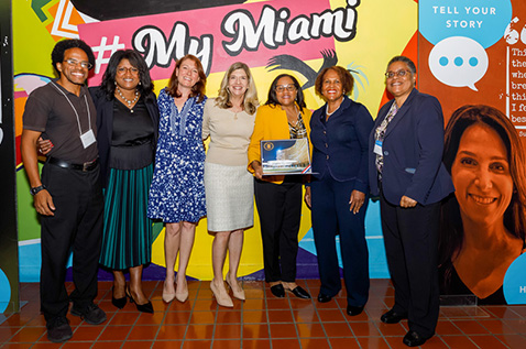 From left: Rob Collins, Education and Outreach Coordinator, Housing Opportunities Project for Excellence (HOPE); Lisa Rice, president and CEO of the National Fair Housing Alliance; Marisa Hightower, associate director of the Office of Civic and Community Engagement (CCE); Robin Bachin, director of CCE and professor of history at the University;  Keenya Robertson, president and CEO of Housing Opportunities Project for Excellence (HOPE); Diane Shelley, principal deputy assistant secretary of fair housing and equal opportunity at the U.S. Department of Housing and Urban Development (HUD); and Vickie D. Johnson, Southeast Housing Program Officer at HUD in Equal Opportunity Compliance gather at the "United for Change" event at HistoryMiami Museum.